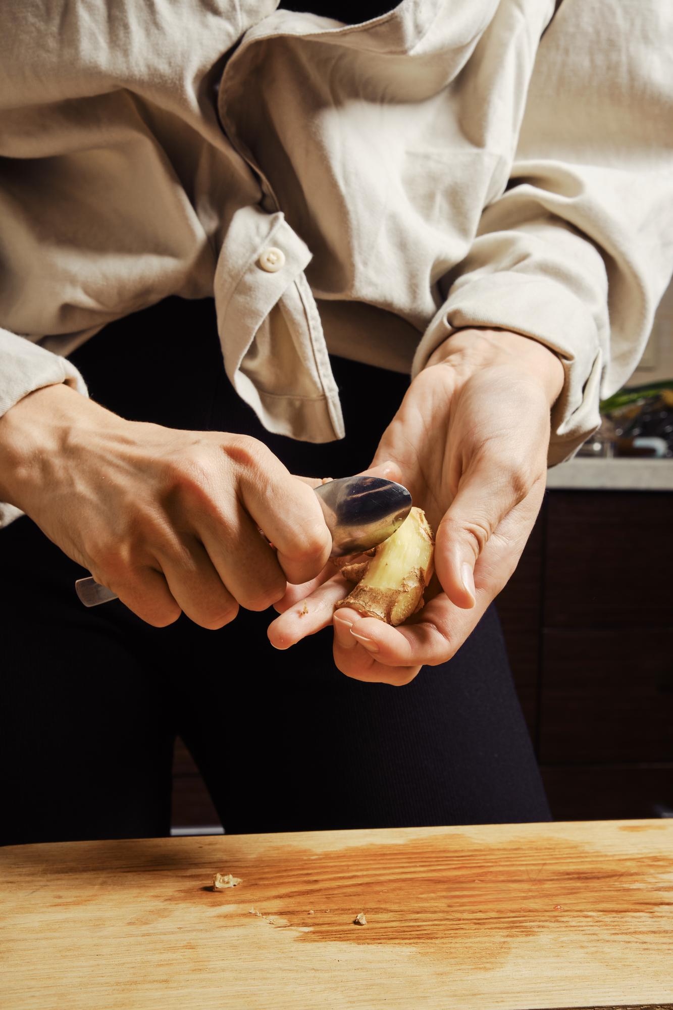 Chef arranging plated dish on wooden table
